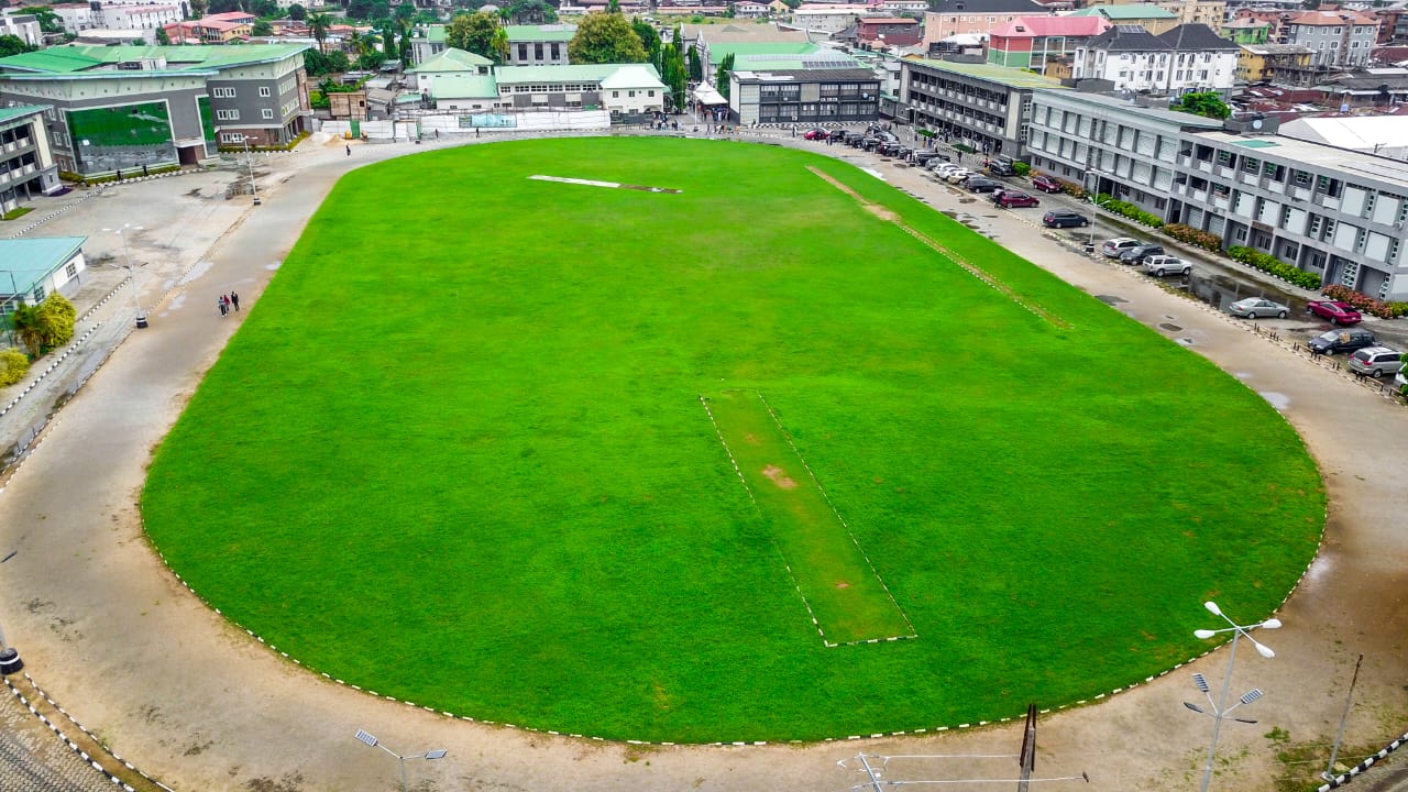 Aerial view of the College sports field ringed by campus buildings