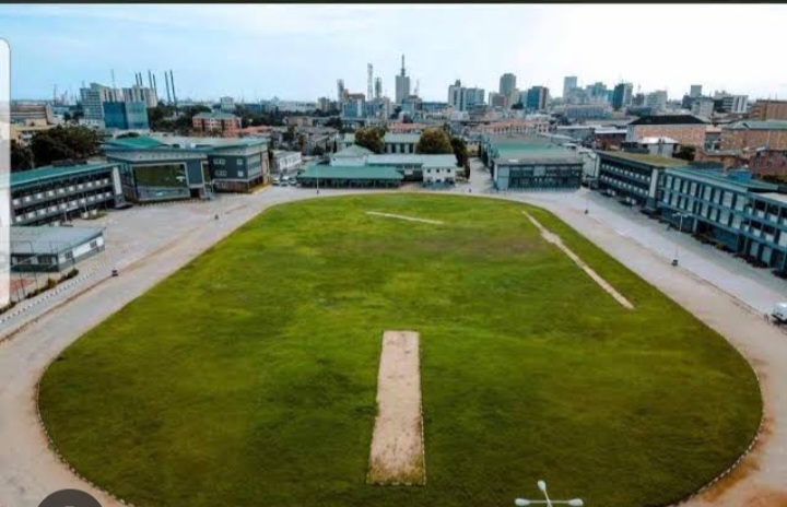 Aerial view of the college campus, sports field and surrounding Lagos skyline