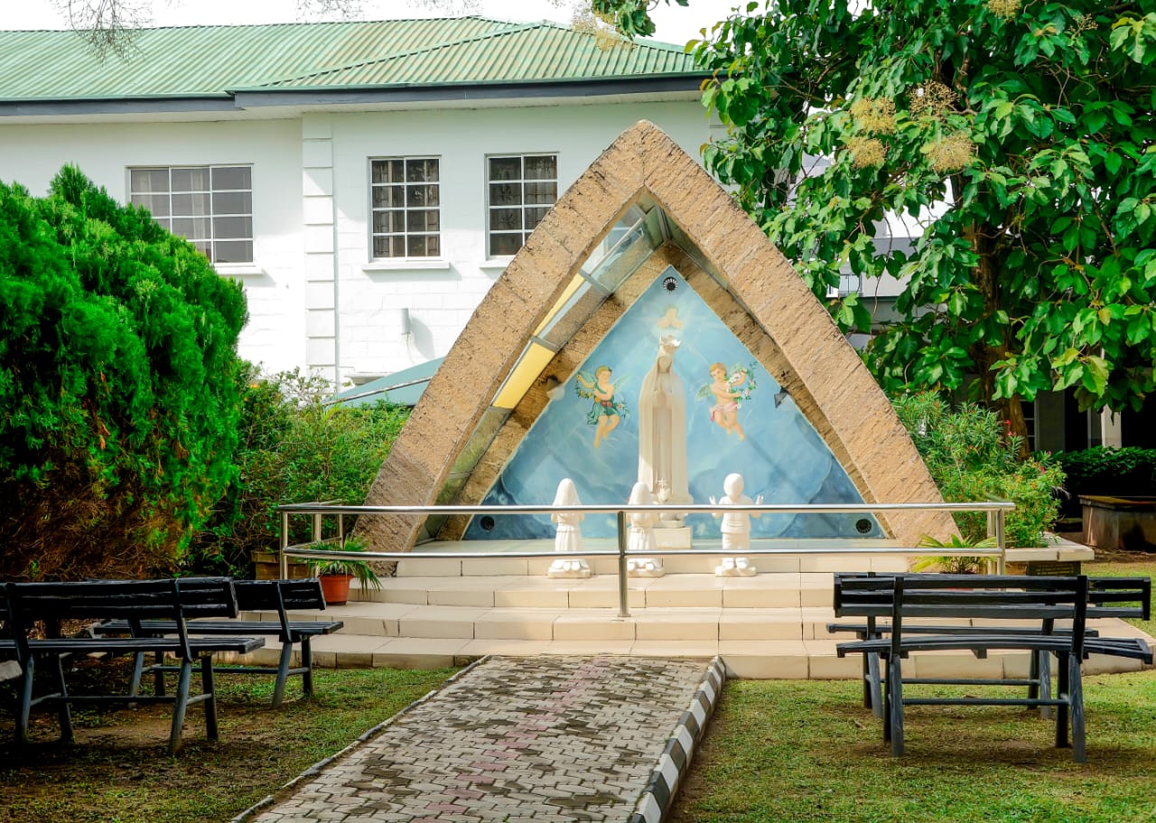 The Marian grotto shrine with benches in the college garden