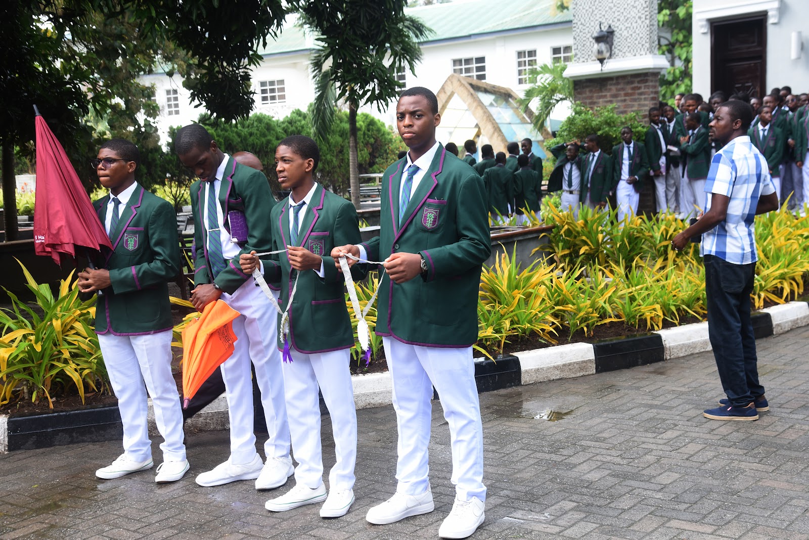 Students in green blazers participating in an outdoor College gathering