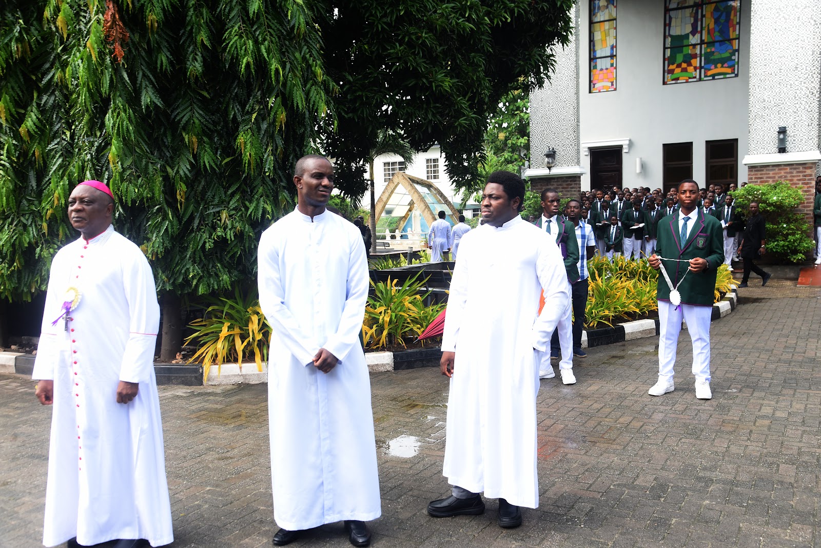 Visiting clergy standing together in the College grounds
