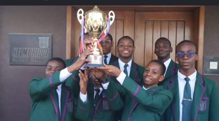 St. Gregory's College students lifting a trophy