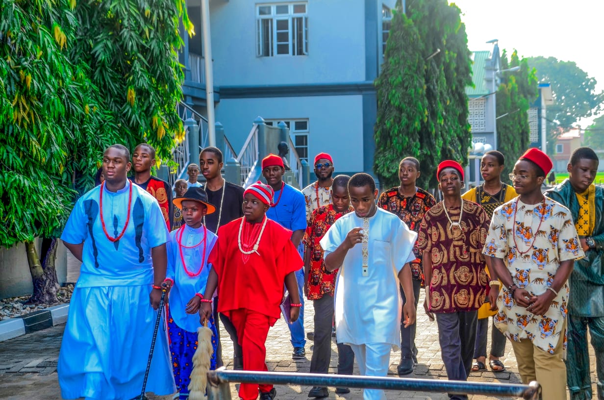 Students in Nigerian traditional dress processing through campus on Cultural Day