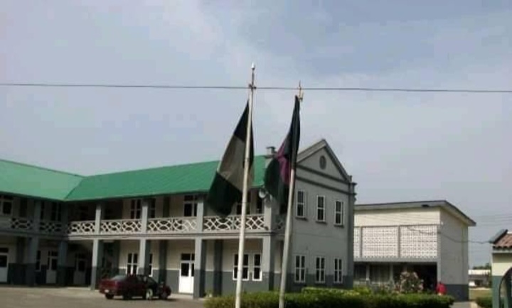 Main building of St. Gregory's College with flags flying