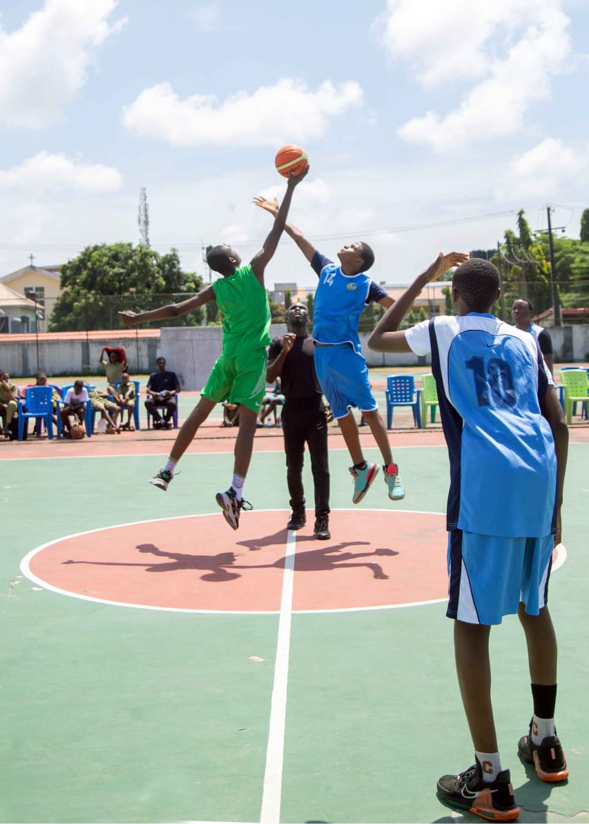 Two players leaping for the ball at a basketball tip-off