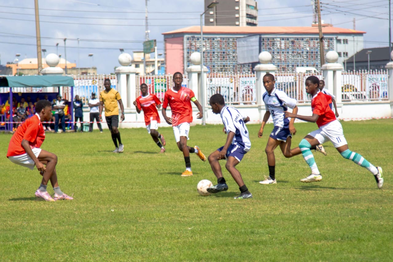 Footballers in red and white contesting the ball