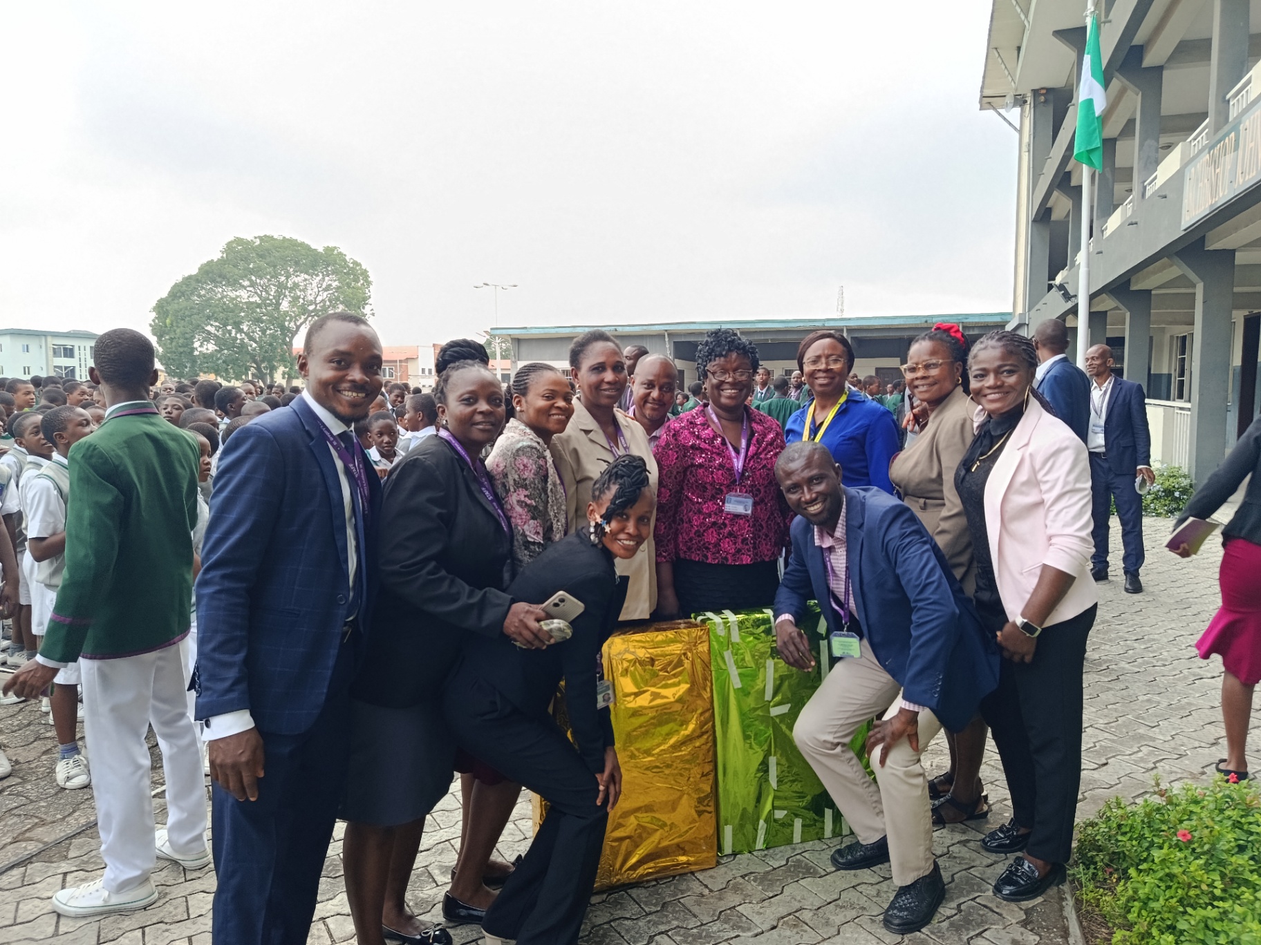 Teachers posing together beside wrapped gifts