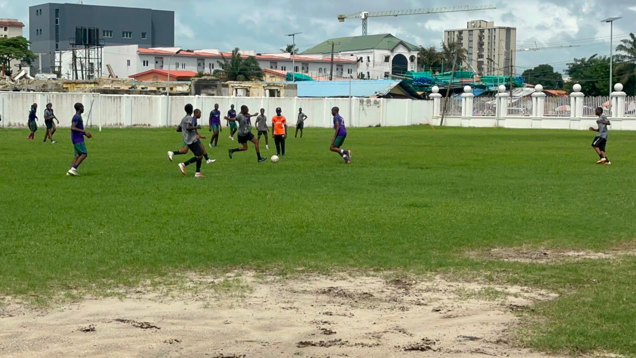 Students playing football on the College field