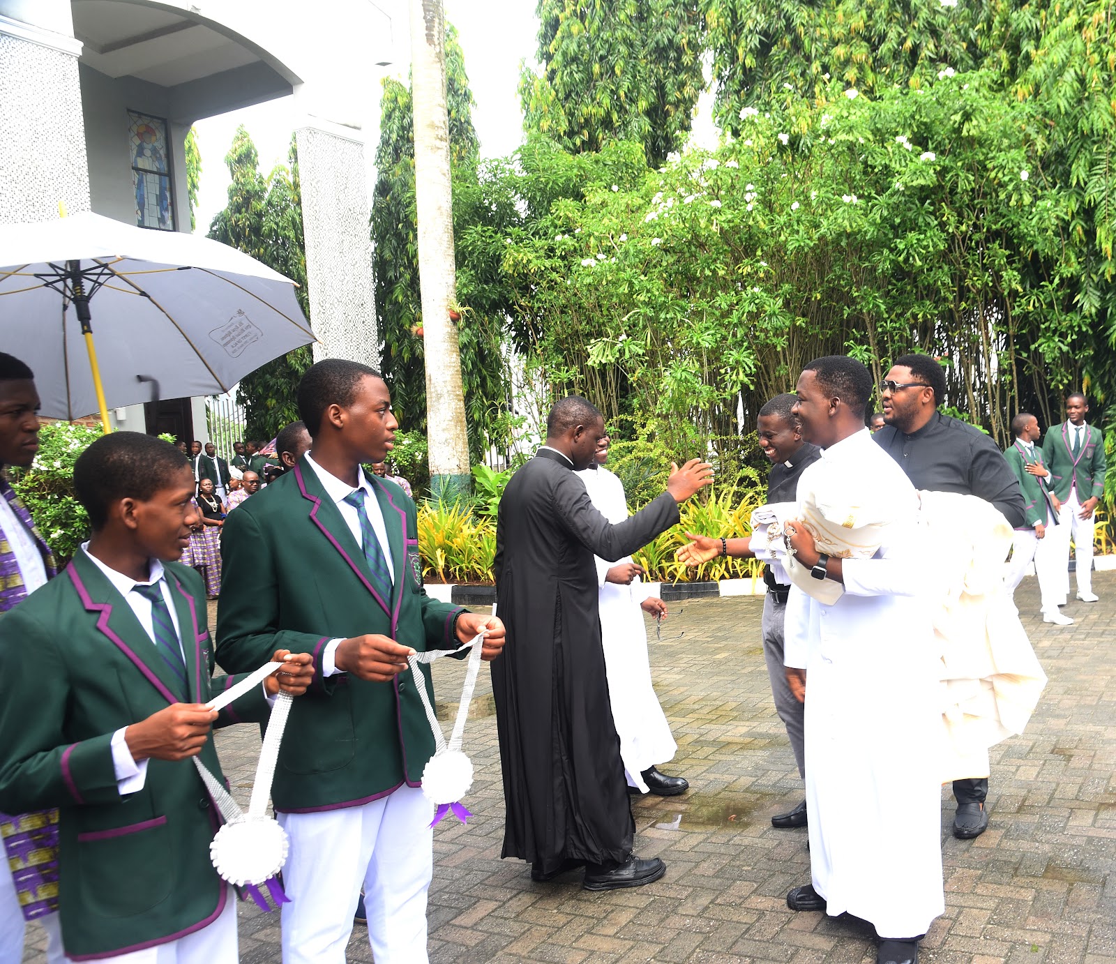 College visitors and members of the community greeting one another outdoors